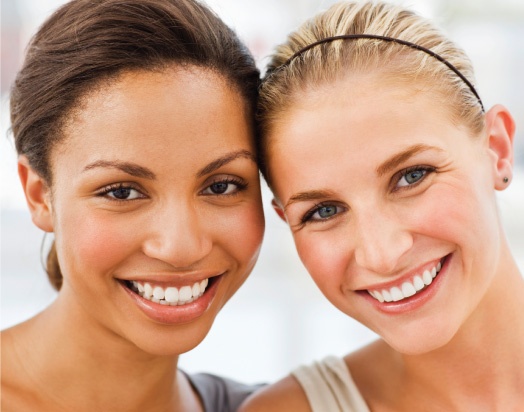 two women with beautiful, white smiles