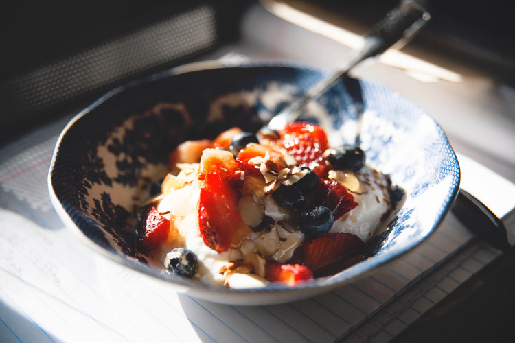 Closeup of a bowl filled with yogurt, granola and fresh berries