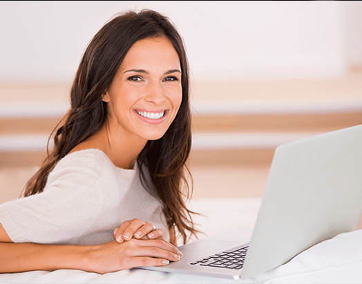 smiling woman at computer