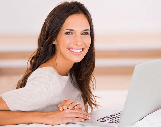 woman smiling with computer