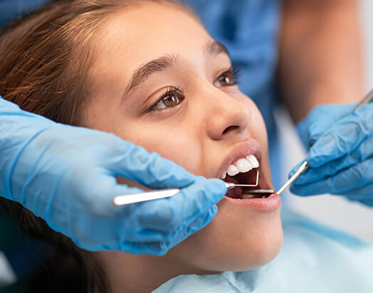 girl receiving a dental exam